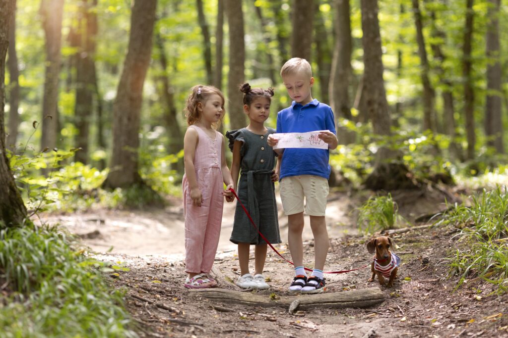 Curious kids participating in treasure trail with little dog