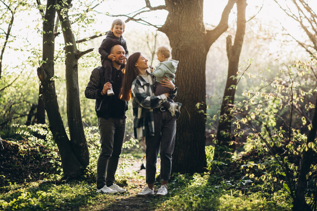 Young family having fun in the woods