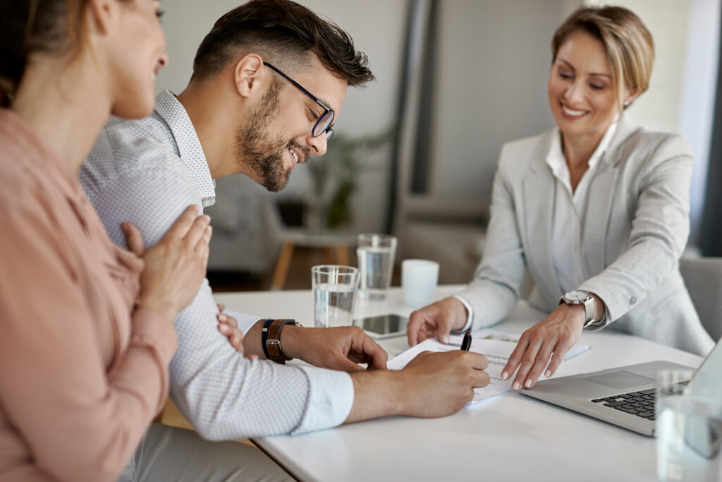 Happy man and his wife meeting a financial advisor