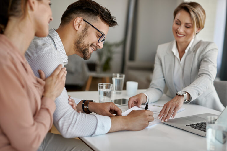 Happy man and his wife meeting a financial advisor