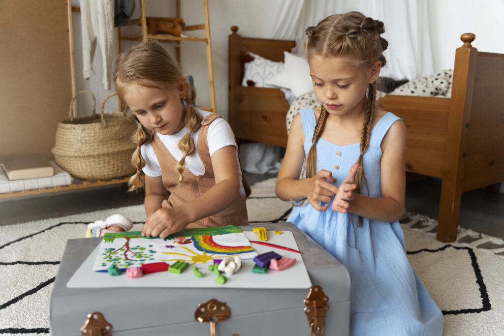 Two girls playing with playdough
