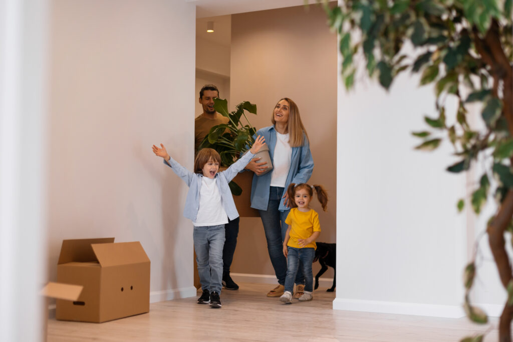 Happy family with dog moving into a new home