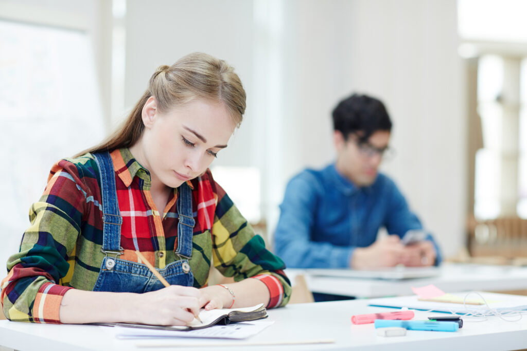 Teen girl and boy taking an exam