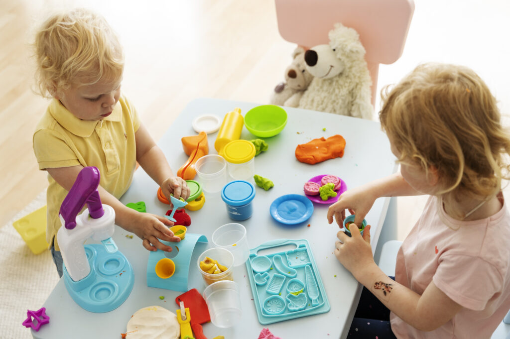 High angle of kids playing Play Doh together