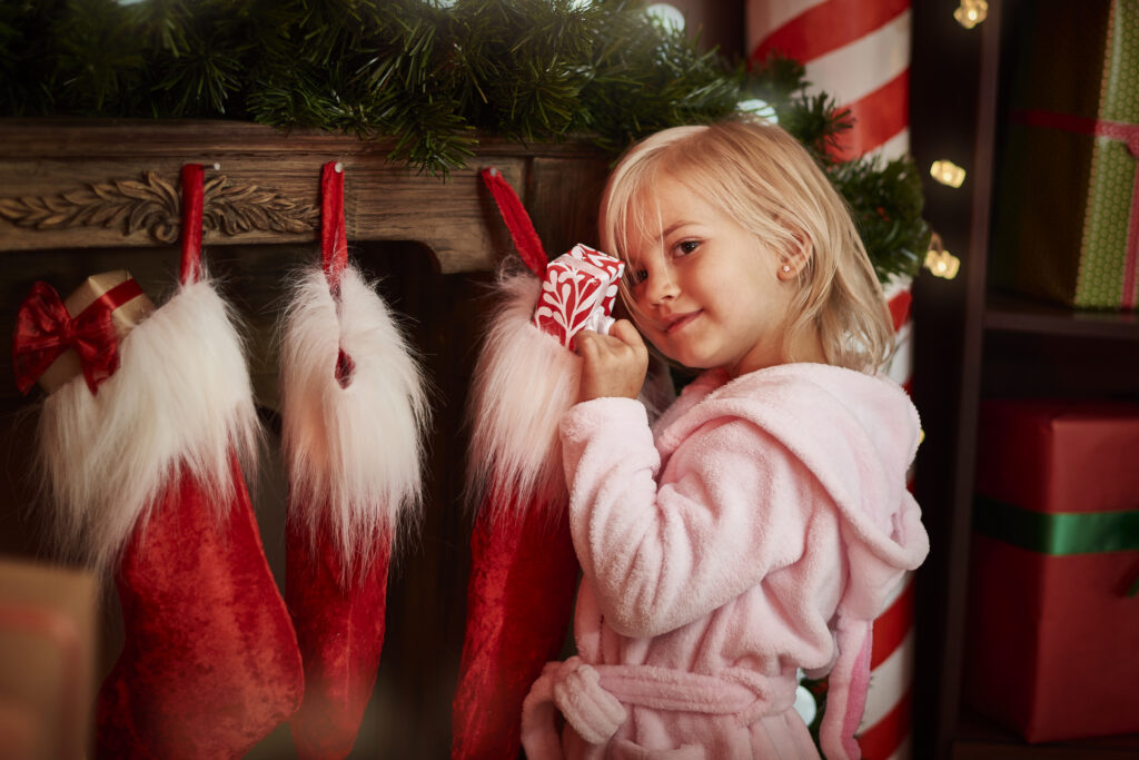 Little girl with Christmas stockings